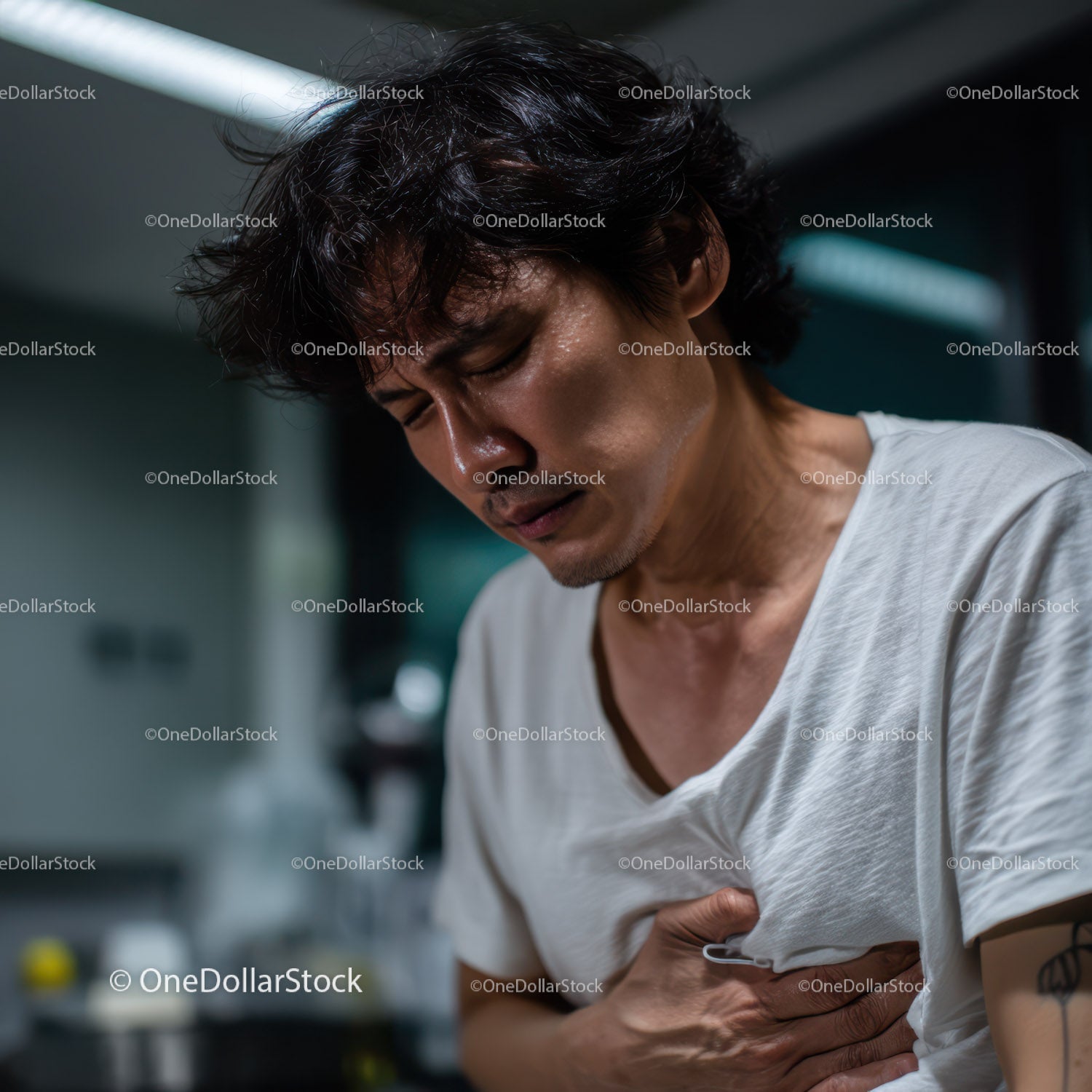Young Man Experiencing Abdominal Pain and Discomfort