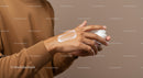 Man Applying Body Lotion for Skin Moisturization in Personal Care Setting