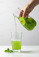 Refreshing green apple juice poured into glass