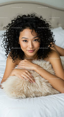 Relaxed young woman lying on bed with soft pillow