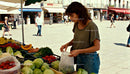 Woman selecting fresh vegetables at outdoor market