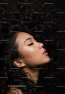 Elegant woman with curly hair in serene profile pose