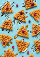 Sweet waffle slices with drizzled chocolate and berries
