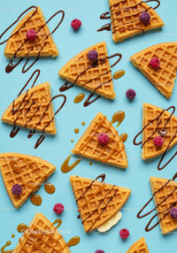 Sweet waffle slices with drizzled chocolate and berries