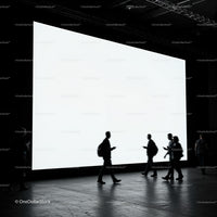 Silhouettes of People Walking Past Bright Screen