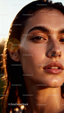 Closeup of woman with fresh dewy skin in golden light