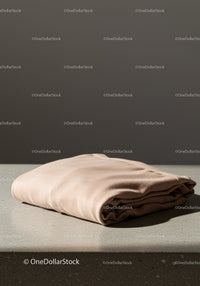 Folded Satin Shirt Display with Light Shadow and Neutral Background