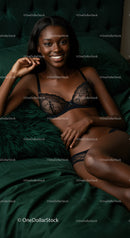 Smiling woman relaxing in elegant black lace lingerie