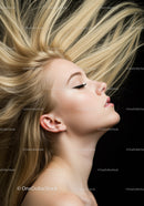 Blonde woman with flowing hair and closed eyes profile
