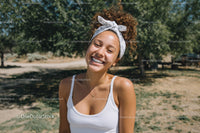 Joyful Woman Smiling Outdoors in Sunlit Park