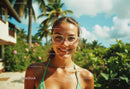Smiling Woman in Sunglasses in a Tropical Outdoor Setting