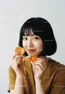 Portrait of a Smiling Woman Holding Fresh Orange