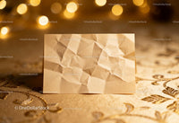 Blank crumpled paper on elegant golden fabric background
