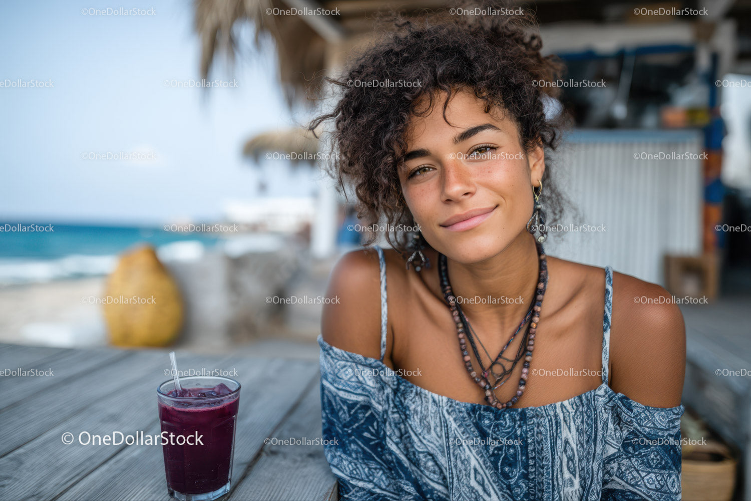 Young Woman Smiling Relaxing at Beachside Cafe with Drink