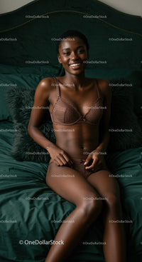 Smiling woman relaxing in elegant lingerie on dark bed