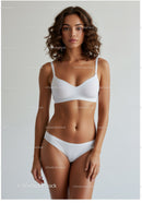 Elegant Woman in White Lingerie Standout Studio Portrait with Soft Lighting