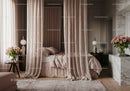 Elegant bedroom with soft pink curtains and fresh roses