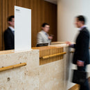 Businessmen interacting at hotel reception desk interior