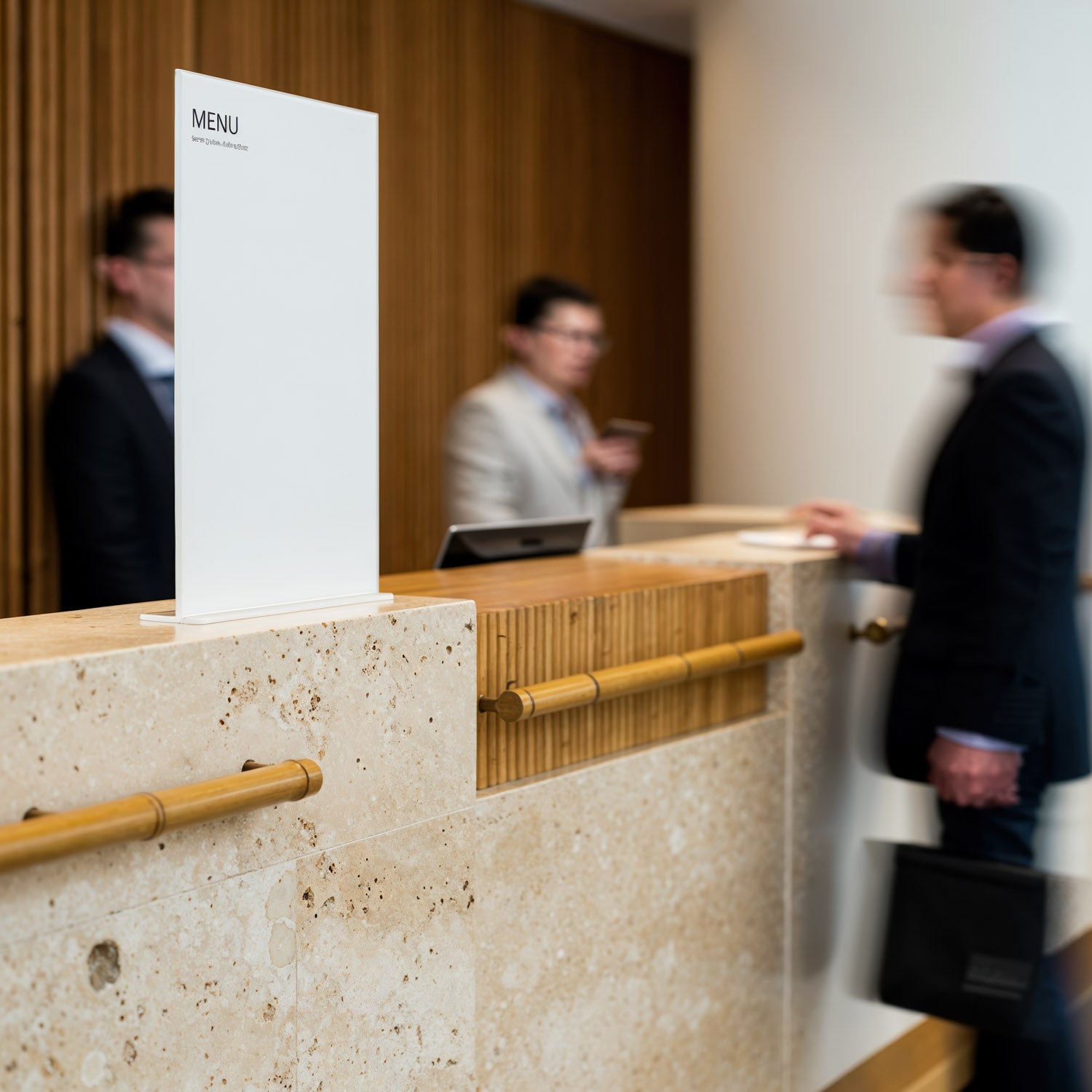 Businessmen interacting at hotel reception desk interior