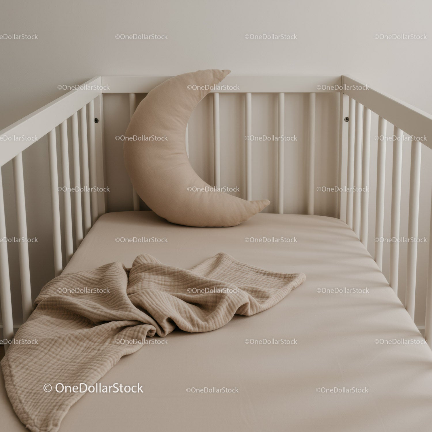 Minimalist baby crib with crescent moon pillow and blanket