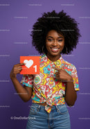 Cheerful Woman Holding Heart Sign in Colorful Outfit