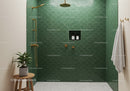 Modern walk in shower with green tiles and gold fixtures