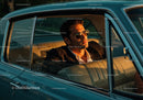 Stylish Male in Sunglasses Driving Vintage Car at Sunset