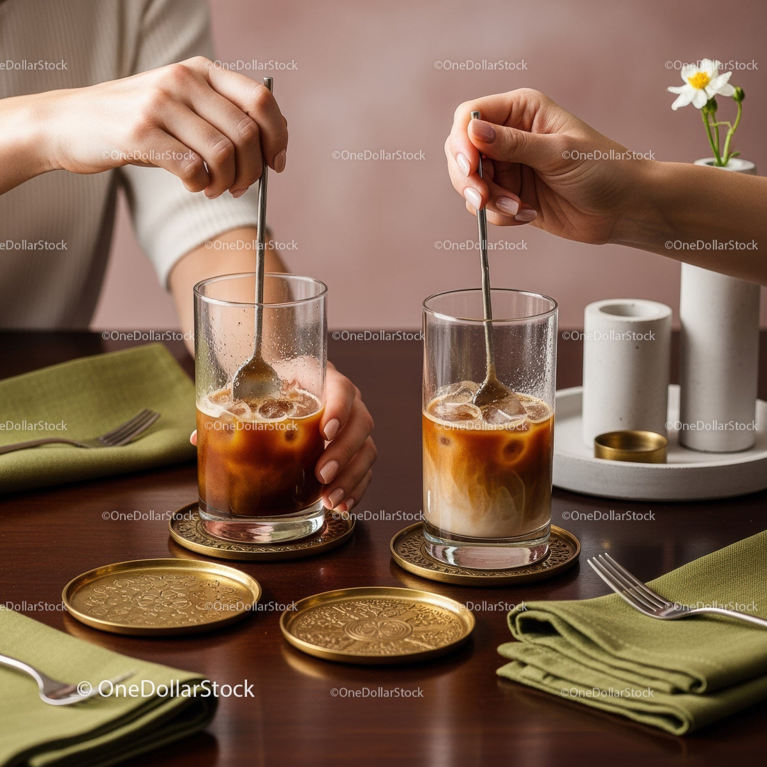Elegant Iced Coffee Drinks with Stirring Hands in Modern Setting