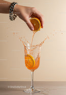 Hand Squeezing Fresh Orange Juice Into Glass