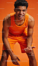 Young athlete showing enthusiasm in orange sportswear