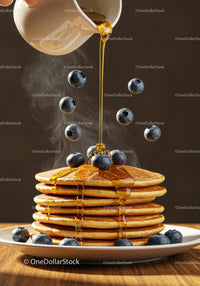 Stack of fluffy pancakes with syrup and fresh blueberries