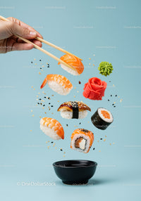 Assorted sushi pieces floating above soy sauce bowl