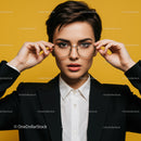 Confident Woman Wearing Glasses in Modern Studio with Yellow Background