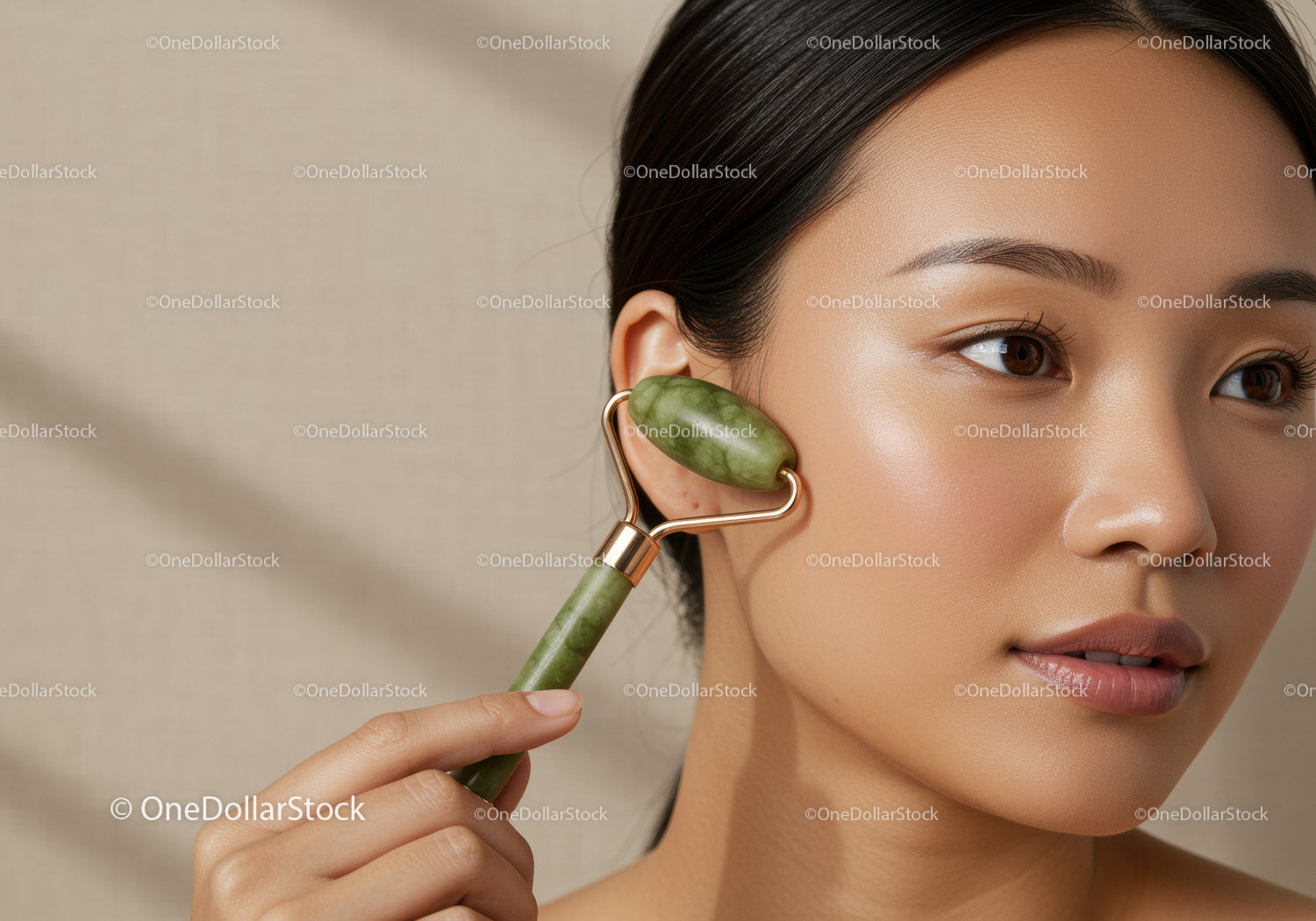 Woman Using Jade Roller for Skin Rejuvenation and Facial Relaxation