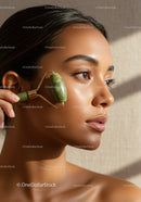 Young Woman Using Jade Roller for Facial Skin Rejuvenation and Beauty