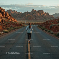 Runner on Remote Road Surrounded by Rocky Desert Landscape