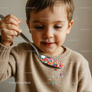 Small boy playing with colorful candy sprinkles