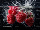 Red Raspberries Splashing into Water in Vibrant Underwater Scene