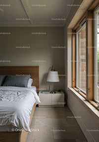 Sunlit Bedroom with Wooden Window Frame and Modern Bedding