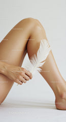Elegant Artistic Nude with Feather and Soft Lighting