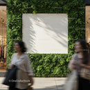 Blank white billboard surrounded by green plants in urban area