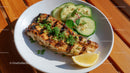 Grilled Fish Fillet with Cucumber and Lemon on White Plate