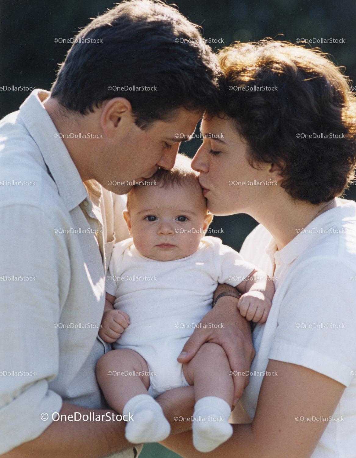 Parents Sharing Tender Moment with Their Baby Outdoors