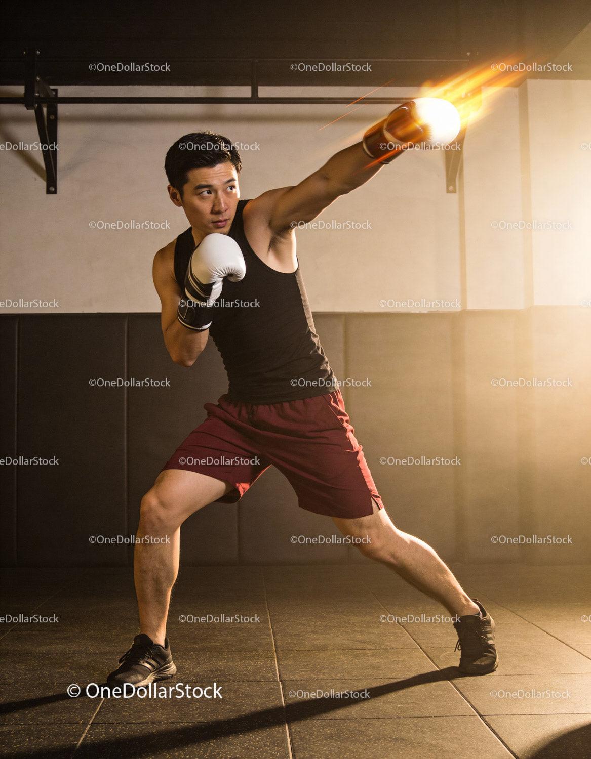 Determined boxer throwing a powerful punch in gym