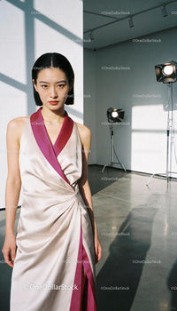 Elegant asian woman in silk dress posing in studio light