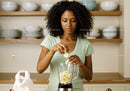 Woman Preparing Banana Smoothie in Modern Kitchen