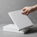 Hand Picking Up a Blank White Hardcover Book