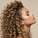 Profile of young woman with voluminous curly hair