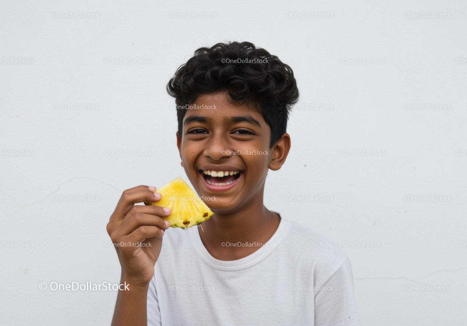 Young Boy Smiling with Pineapple on White Background For Summer Concept
