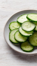 Fresh Cucumber Slices in White Bowl for Healthy Refreshing Snack